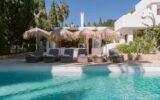 Group villa Ibiza with pool and padel court surrounded by Mediterranean gardens