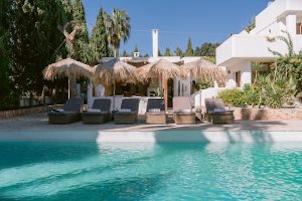 Group villa Ibiza with pool and padel court surrounded by Mediterranean gardens